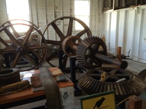 display of the king gear coming up from the vertical access turbine below the mill - with wooden teeth and the horizontal shaft with iron gears.  Wooden teeth are cheap, easily replaced and with break if something jams in the mill works - a built in planned weak spot