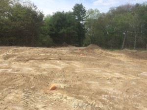 All rock ledge under there - tremendously difficult to photograph properly - but all the 'scrapey' areas are sheer rock with a fine layer of dust on them. The rocks with orange paint on them are the locations where orange stakes used to be - corners of the foundation locations