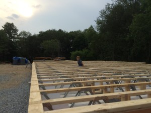Floor joists are all in and ready for the underfloor and the wall systems to go up.  Mason showing off some parallel bars moves after sneaking around from underneath