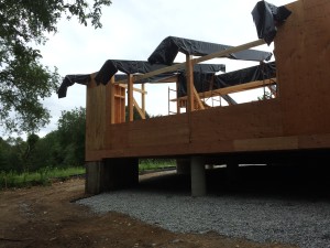 From down slope back up to the living room. Fireplace stack on the left hand corner