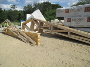 Trusses have arrived and are unpacked. These cover the mechanical space and the bedrooms. A complex and interesting design while still being cost effective. Note the flat plates - these are the connector plates that make the trusses much more affordable AND strong. According to the wiki page on the inventor of this technology, houses built in Florida with these connectors were much more likely to have survived Hurricane Andrew. https://en.wikipedia.org/wiki/John_Calvin_Jureit 