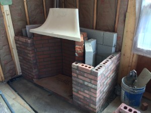 The Rumford Fireplace taking shape. The hearth will be a piece of bluestone. Note the chimney is square but is at an angle in the corner - Deck House designed it this way in order to angle the fire more towards the room instead of just sitting in the corner